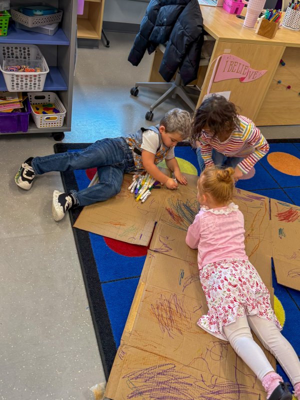 Decorating a giant No. 1 made from a cardboard box are (l-r) Noah Wiedorfer, Marlee Catlett and Hadley Reed.